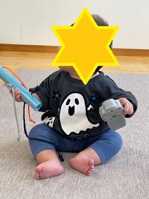 ハロウィンのおばけのトレーナーを着た幼児の写真