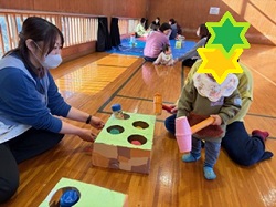 モグラたたきで遊ぶ親子の写真